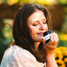 Woman enjoying the scent of an aromatherapy product
