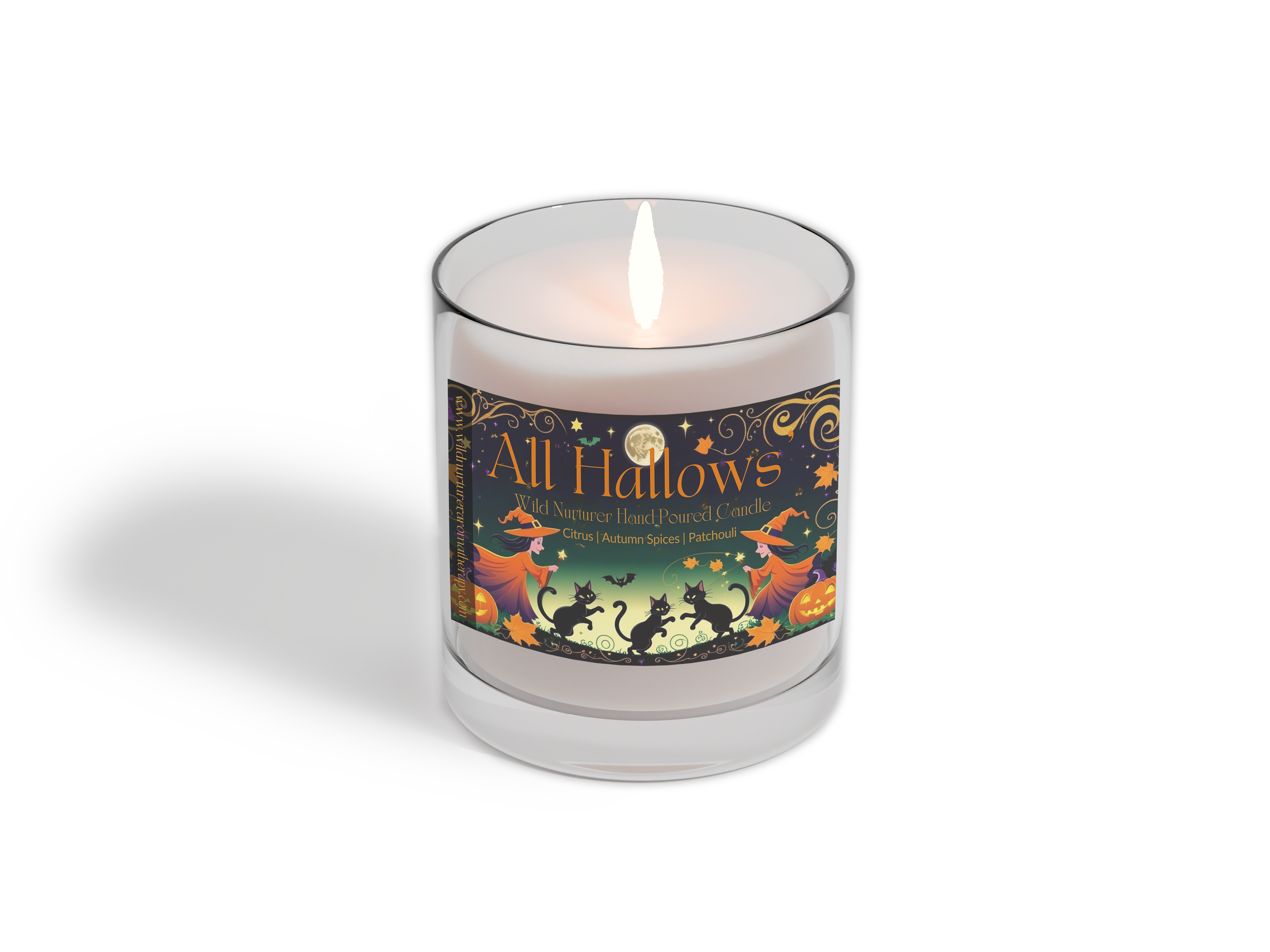 A lit, hand-poured Wild Nurturer Aromatherapy candle from the Candle Club - Monthly Subscription Delivery, featuring a Halloween-inspired "All Hallows" design with witches, pumpkins, and autumn motifs.