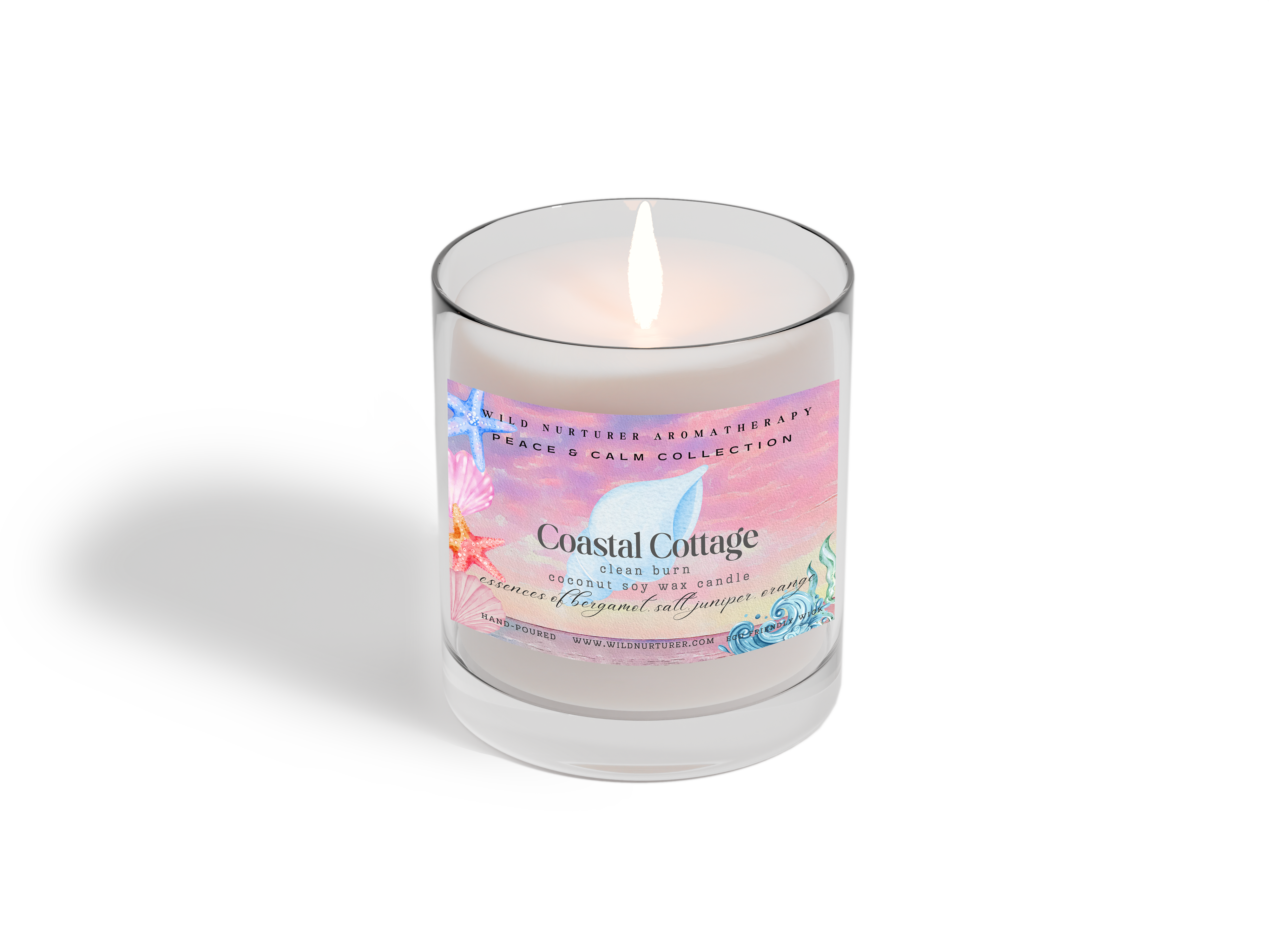 The Heaven & Earth Aromatherapy Coastal Cottage Hand Poured Soywax Candle features a pastel starfish and seashell design. Part of the Peace & Calm Collection, it offers an ocean scent for a soothing atmosphere.