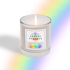 The lit Chakra Candle - Coconut Soy Wax Candle 8oz by Heaven & Earth Aromatherapy glows in a clear glass jar with "Chakra Balance" label, casting a rainbow reflection—ideal for meditation.