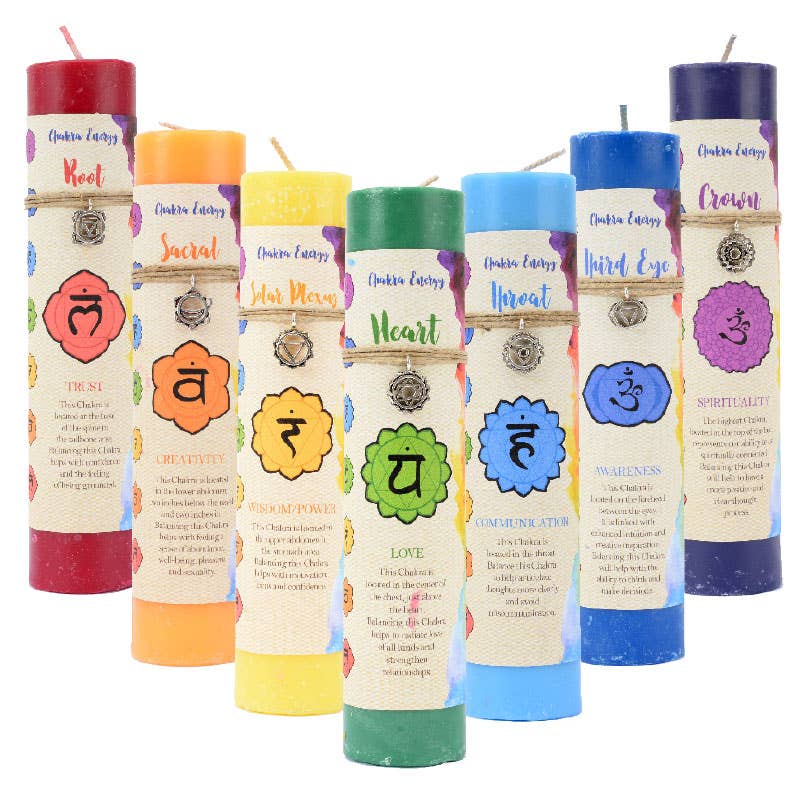 The Benjamin International Chakra Pillars set includes six unscented, 7'' tall candles in vibrant chakra colors: Root (red), Sacral (orange), Solar Plexus (yellow), Heart (green), Throat (blue), Third Eye (indigo), and Crown (purple). Each features symbols and a pewter pendant for elegance.