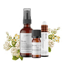 Three Bloom Exotic Aromatherapy & Skincare Blend products by Wild Nurturer Aromatherapy, featuring spray and dropper bottles surrounded by white floral accents on a white background.